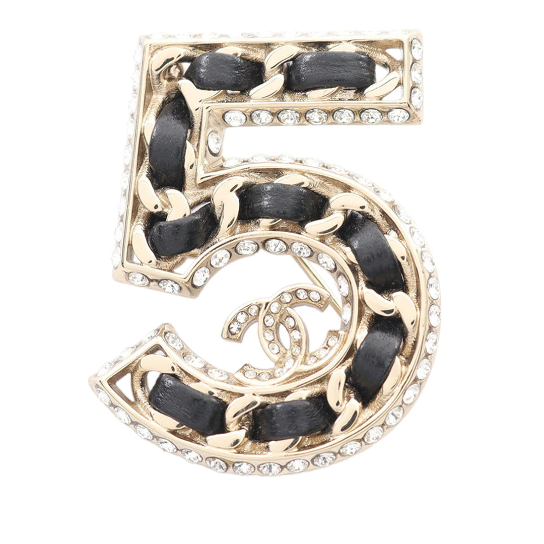 Chanel Broche CC Tissé Chaîne Number 5 Cuir d'agneau plaqué or Noir – vue principale – GABY PARIS