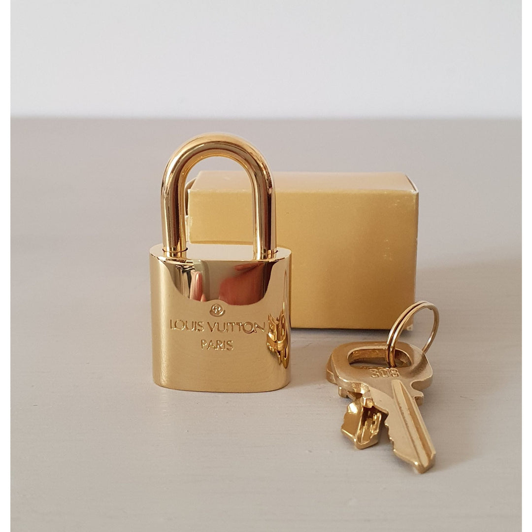 LOUIS VUITTON padlock in golden brass